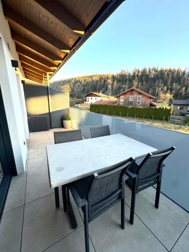 a table and chairs on a patio with a view at Alpin Apartments in Radstadt