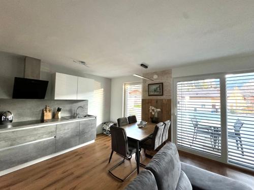 a living room with a table and a kitchen at Alpin Apartments in Radstadt