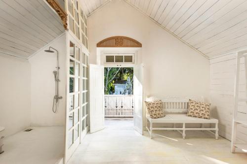 a white hallway with a bench in a house at Villa Havana Hues Private Villa in Bentota
