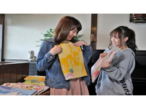 two women are holding up a package at Inatori Tokai Hotel Yuen - Vacation STAY 61026v in Inatori
