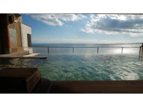 a swimming pool with a view of the ocean at Inatori Tokai Hotel Yuen - Vacation STAY 48876v in Inatori