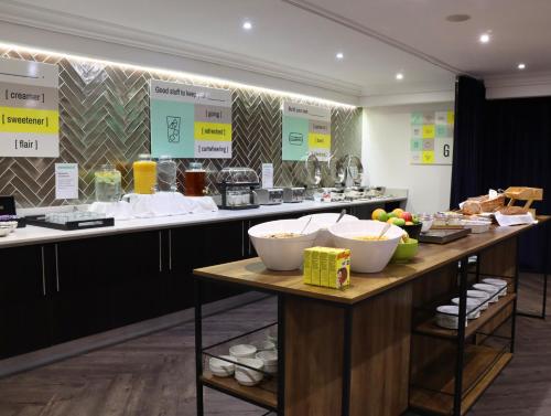 a buffet line with bowls of food on display at Garner Hotel Preston Samlesbury by IHG in Preston