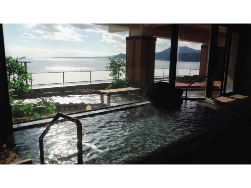 a bath tub with a view of the ocean at Inatori Tokai Hotel Yuen - Vacation STAY 61011v in Inatori