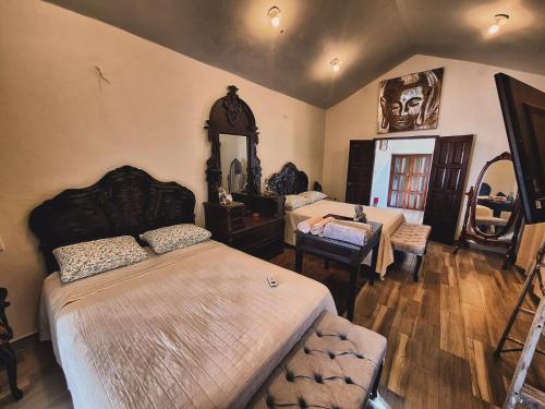 a bedroom with two beds and a mirror at Hotel River Blue in Tlacotalpan