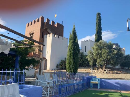 a building with chairs and a fence in front of it at Torre Calera in Arganda del Rey