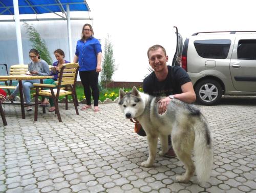 a man and a dog standing in a patio at Art Hostel in Tashkent