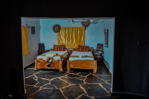 a bedroom with a bed and a couch in it at Jaffrane in Ukunda