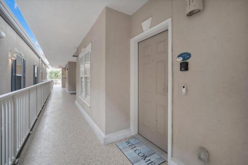 a hallway with a white door in a building at Tybee Turtle Time Condo in Tybee Island