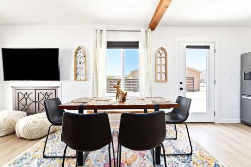 a living room with a table and chairs at Desert Escape Climbing Wall, Hammocks & Hot Tub15 Min to Joshua Tree Park in Joshua Tree