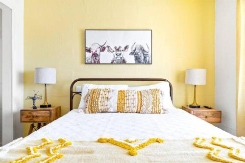 a bedroom with a white bed with two lamps at Desert Escape Climbing Wall, Hammocks & Hot Tub15 Min to Joshua Tree Park in Joshua Tree