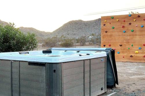 a hot tub in front of a climbing wall at Desert Escape Climbing Wall, Hammocks & Hot Tub15 Min to Joshua Tree Park in Joshua Tree