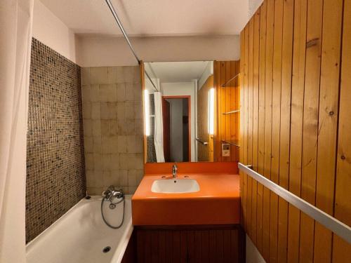 une salle de bain avec un lavabo, une baignoire et un miroir dans l'établissement Résidence Lac Du Lou - Studio 4 pers ski aux pieds au coeur des Menuires MAE-5054, aux Menuires