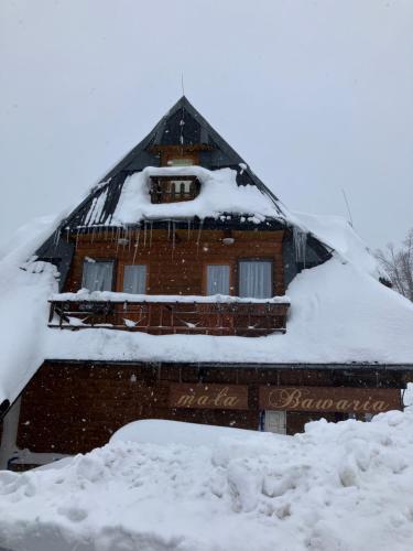 a house is covered in snow at Mała Bawaria in Zakopane