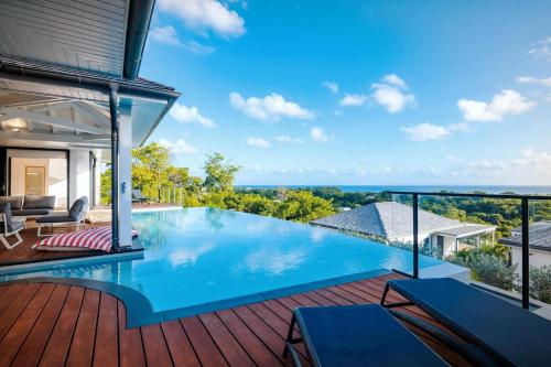 a swimming pool on the deck of a house at Villas Vista Del Mar in Sainte-Anne