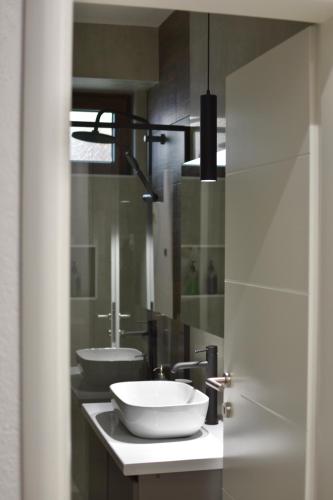 a bathroom with two sinks on a counter at L 25 Apartments in Bitola