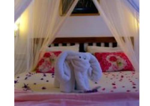a white toy elephant sitting on top of a bed at Ivory Safari Lodge in Udawalawe