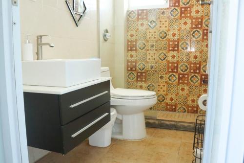 a bathroom with a sink and a toilet and a shower at Summer Apt Minutes From The Beach in Boqueron