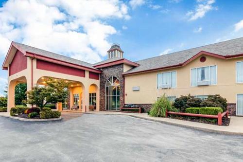 a large house with a driveway in front of it at Precious Hotel in Carthage