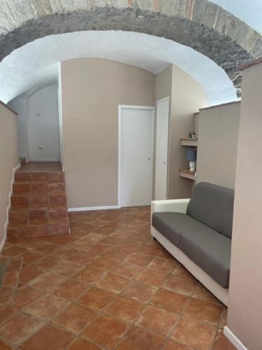 a living room with a couch and a tile floor at CASA BELLAVISTA - Charming House in Campagnano di Roma