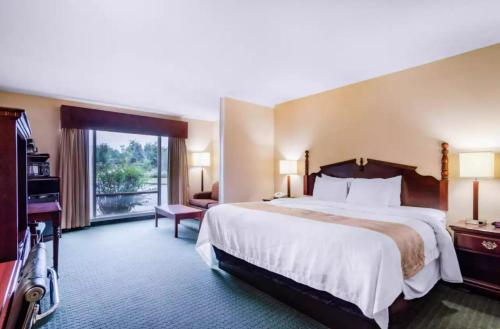 a hotel room with a large bed and a window at Precious Hotel in Carthage