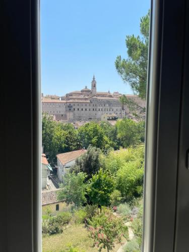 a view of a large building from a window at Appartamento San Marco in Iesi