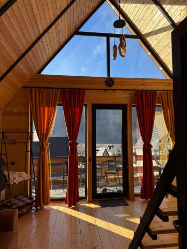 a large window in a room with a view at Kazbegi Inn Cottages in Stepantsminda