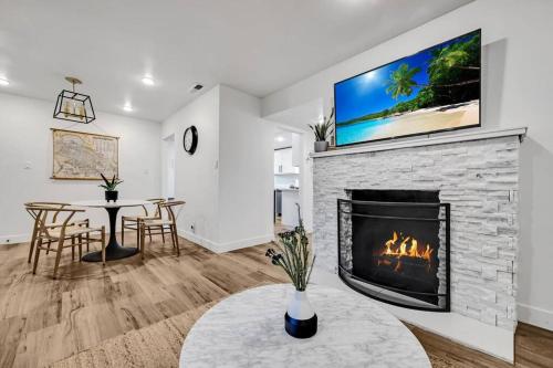 a living room with a fireplace with a tv above it at Remodeled West Sacramento home in quiet location! in West Sacramento