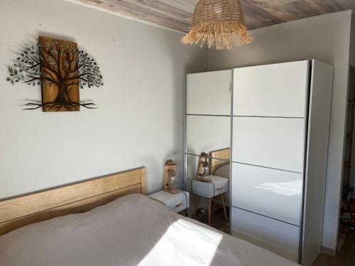 a bedroom with a bed and a tree picture on the wall at Valberg 3 pièces au pied des pistes in Péone