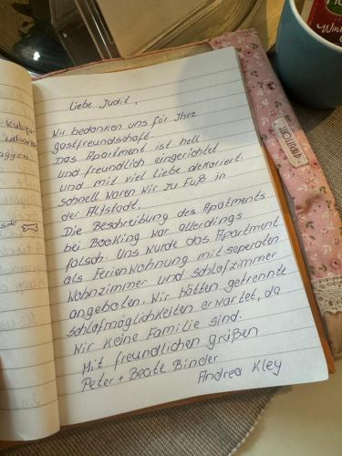 a diary with handwriting on it sitting on a table at Korona Apartman Székesfehérvár in Székesfehérvár