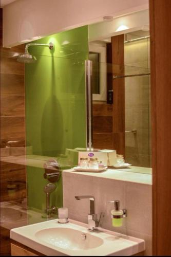a bathroom with a sink and a mirror at City Center Apartment Sarajevo Accross BBI Shopping Mall in Sarajevo
