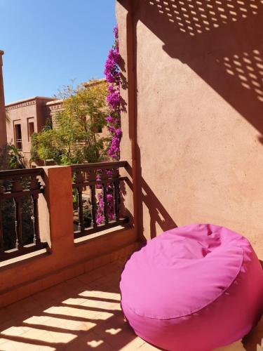 a pink bean bag chair sitting on a balcony at appart jardin de l atlas Marrakech Waky Beach Golf Montagne de l Atlas in Marrakech