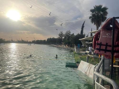 two people swimming in a body of water at appart jardin de l atlas Marrakech Waky Beach Golf Montagne de l Atlas in Marrakech