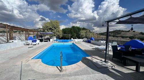 a swimming pool with lounge chairs at Torre Calera in Arganda del Rey
