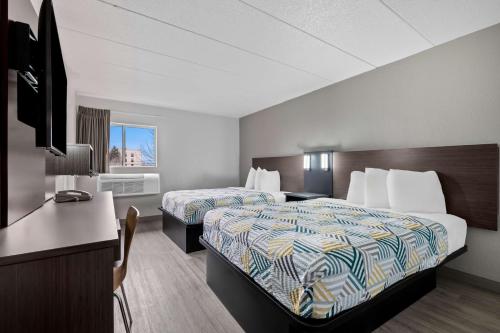 a hotel room with two beds and a desk at Motel 6-Portland, ME in Portland