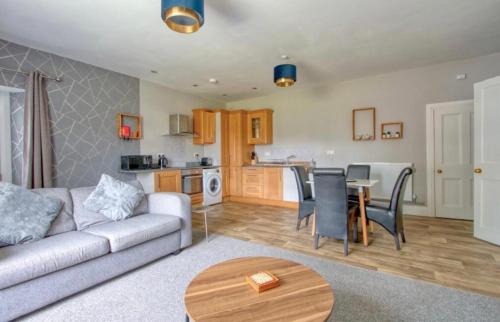 a living room with a couch and a table at Countryside Annexe, with hottub, sleeps up to 4 in Durston