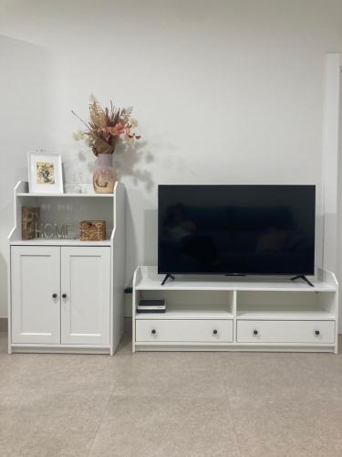 a white entertainment center with a flat screen tv at Mon Art in Logroño