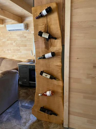 a wall with bottles of wine in a room at Vikendica ANA in Šipovo