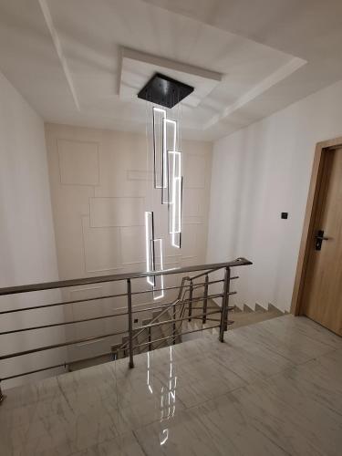 a room with a table and a chandelier at Nara Luxe -- 24hours Power Supply, Board games, Pool and Gym in Lagos