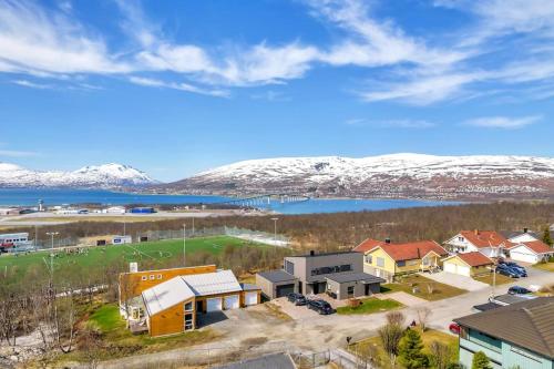 an aerial view of a town with snow covered mountains at Elegant 4BR villa with great views and location in Tromsø