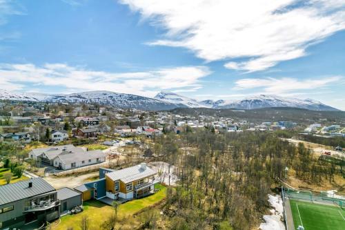 an aerial view of a city with snow covered mountains at Elegant 4BR villa with great views and location in Tromsø