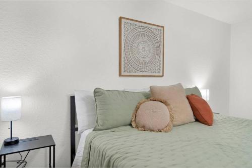 a bedroom with a bed with pillows on it at Spacious Modern Retreat and Spa in Tomball