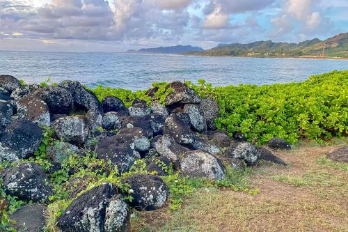 a pile of rocks on the shore of the ocean at Islander on the Beach 164 in Kapaa
