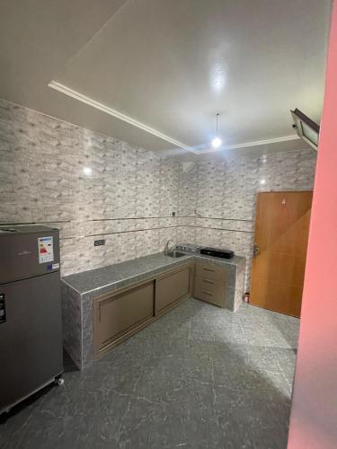 an empty kitchen with a counter and a refrigerator at amalou guest house in Imsouane