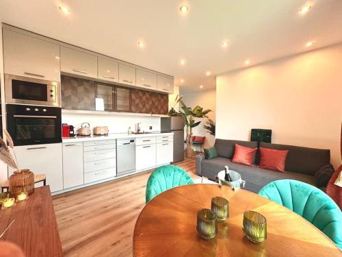 une cuisine et un salon avec une table et un canapé dans l'établissement Suite Love & Relax, à Esbly