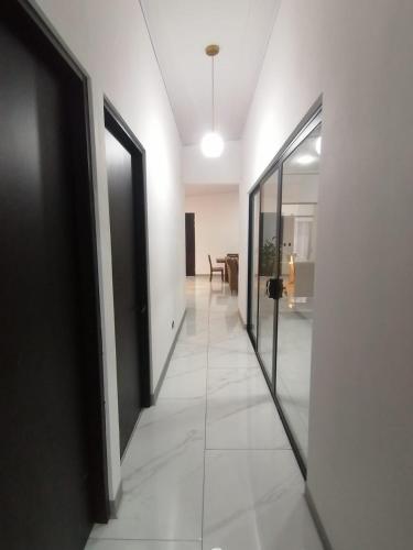 a hallway with doors and a room with a table at Casa Pacifica in Uvita