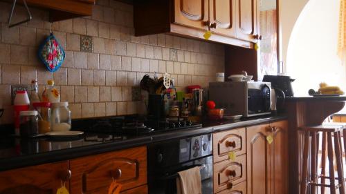 a kitchen with a stove and a counter top at Marsalforn's Cosy Room in Marsalforn