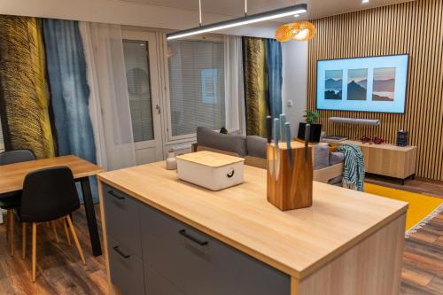 a kitchen with a table and a living room at City Luppo - Spacious, Smart, Warm, Sauna, Wi-Fi in Rovaniemi