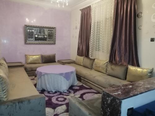 a living room with a couch and a table at Casandalus in Larache