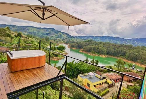 a bath tub on a deck with a view of a river at La Finca De Frida in Guatapé