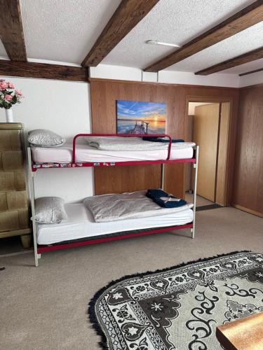 a room with two bunk beds and a rug at Familie Zimmer in Ramsen